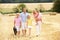 Family Walking Together Through Summer Harvested F