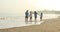 Family walking on the tropical coast