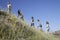 Family Walking Up Grass Slope