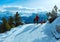 Family walking on winter mountain slope