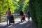 family walks with children in strollers in the Park