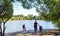 A family walks near the pond in the Pokrovskoe-Streshnevo Natural and Historical Park. Moscow. Russia