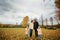 Family walks in the park in autumn.