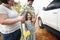 Family washing their white car