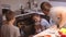 Family watch as a pie is prepared in the oven. Happy childhood. Make homemade food together.