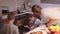 Family watch as a pie is prepared in the oven. Happy childhood. Make homemade food together.