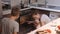 Family watch as a pie is prepared in the oven. Happy childhood. Make homemade food together.