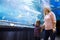 Family watchig fishes at a aquarium