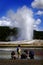 Family Watching Old Faithful in Yellowstone National Park in American West