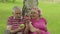 Family weekend picnic in park. Active senior old caucasian couple sit near tree and eating fruits