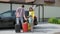 Family weekend, portrait of joyful friendly family in medical masks with suitcases gathered to go on trip by car during