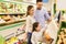 Family weighing oranges on scale at grocery store