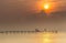 Family welcome sunrise on wooden bridge