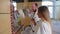 A family in white bathrobes standing in the bathroom and brushing their teeth