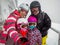 Family on winter vacations taking selfie on mountain slope