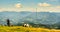 Family and woman with dog enjoying view over mountains from Schockl in Graz, Austria