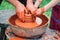 Family working on pottery wheel. Potters and child hands. Pottery workshop outside