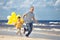 Family with yellow balloons playing on the beach