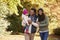 Family With Young Daughter Enjoying Autumn Countryside Walk