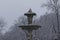 Famous Alcachofa fountain, in Retiro, Madrid, in a snowy day