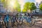 Famous Amsterdam view - parked bicycles next to the canal, view of the traditional bridge and houses. A beautiful sunny day.