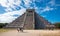 Famous ancient Mayan pyramid at Chichen Itza against dramatic morning sky