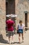 The famous archaeological site of Pompeii UNESCO heritage. Couple of tourists under the scorching sun.