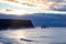 Famous basalt sea stacks of Reynisdrangar, rock formations on the black sand of Reynisfjar beach, view not far from Vik, a small v