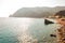 The famous beach full of deckchairs, sun umbrellas parasols, sunbathing and swimming tourists in Monterosso Al Mare, Cinque Terre