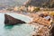 The famous beach full of deckchairs, sun umbrellas parasols, sunbathing and swimming tourists in Monterosso Al Mare, Cinque Terre