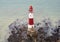 The famous Beachy Head lighthouse located on the rocky beach of Beachy Head the chalk headland cliff in East Sussex