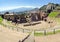 The famous and beautiful ancient greek theatre ruins Taormina with Etna volcano in the distance