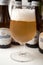 The famous belgian Hoegaarden of white bier in glass on bottles background