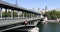 Famous Bir Hakeim bridge with people and tourists in a sunny summer day in Paris