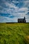 Famous black church Budir with green meadows and blue sky on Snaefellsnes peninsula Iceland