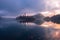 Famous Bled Lake in Triglav National Park in the Julian Alps with a forest in autumn colors at sunrise