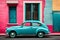 Famous bright color retro car parked by colorful houses in Bo Kaap district in Cape Town.