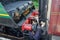 Famous British Steam Locomotive seen with its driver, with the driver cooling up a passenger railway carriage.