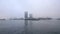 Famous buildings of Amsterdam city centre at foggy day. General landscape view of city embankment with rush boats. Time Lapse.