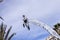 Famous Carnival of Nice, Flowers` battle. Clouds on clear blue sky with an acrobat in businessman suit