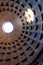 The famous cassette ceiling dome of Pantheon temple of all the gods with wide open rotunda on the top. Sunlight rays penetrating