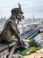 A famous chimera statue of Notre-Dame de Paris cathedral, gazing at the city from the towers gallery