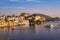 The famous city palace on Lake Pichola reflecting sunset light. Udaipur, travel destination and tourist attraction in Rajasthan, I