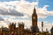 Famous cityscape view of London. Westminster bridge full of walking people and amazing Big Ben under reconstruction on the
