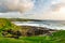 Famous Classiebawn Castle in picturesque landscape of Mullaghmore Head. Spectacular sunset view with waves rolling ashore.