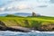 Famous Classiebawn Castle in picturesque landscape of Mullaghmore Head. Spectacular sunset view with waves rolling ashore.