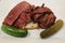Famous Corned Beef and Pastrami on rye sandwich served with pickles