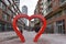 Famous Distillery District with a big heart sculpture and many red buildings in Toronto, Canada