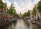 Famous dutch canal and traditional old buildings in Red Light District of Amsterdam.