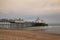 Famous Eastbourne Pier and beach in cloudy day.